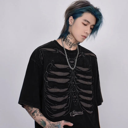 VOIDWEAR VDR_VANISH_05 ripped skeleton tee washed vintage cotton men’s summer streetwear USA. Person wearing a black skeleton design shirt with tattoos and blue hair.