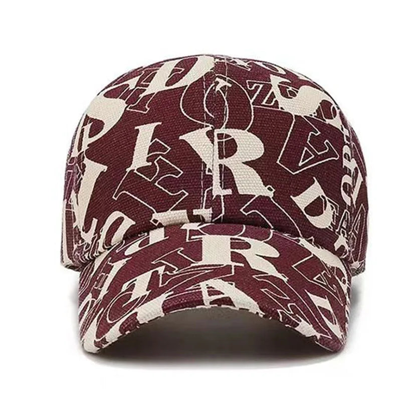 SIGNAL_VANISH_06 Cap | VOIDWEAR Ritual-Inspired Streetwear. Maroon and beige cap with letter pattern on a white background