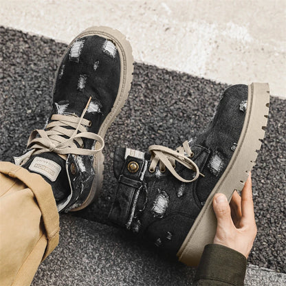 VOIDWEAR SIGNAL_VANISH_12 ☰ men’s denim ankle boots with lace-up closure, EVA insole, rubber outsole, ritual-inspired streetwear design. Black distressed boots with beige soles worn by a person on a textured surface.