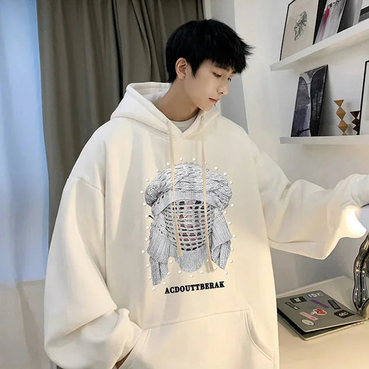 VOIDWEAR VDR_SHDW_07 oversized goth hoodie with masked figure graphic, in black, styled in urban streetwear fit. Person wearing a white hoodie with a graphic design in a room.