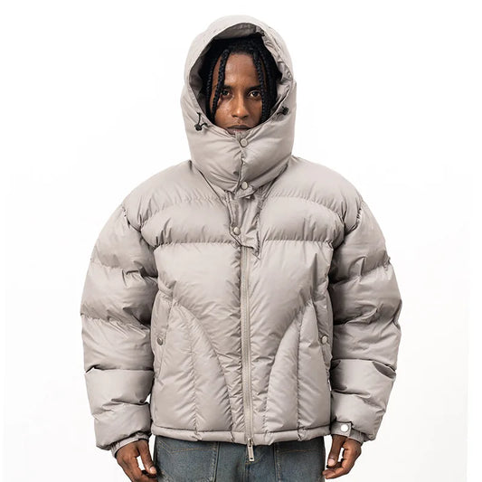 VOIDWEAR VDR_VANISH_05 ritual streetwear winter hooded jacket, oversized black coat with vanish-mode hood and signal glyph sleeve. Person wearing a gray puffer jacket on a white background